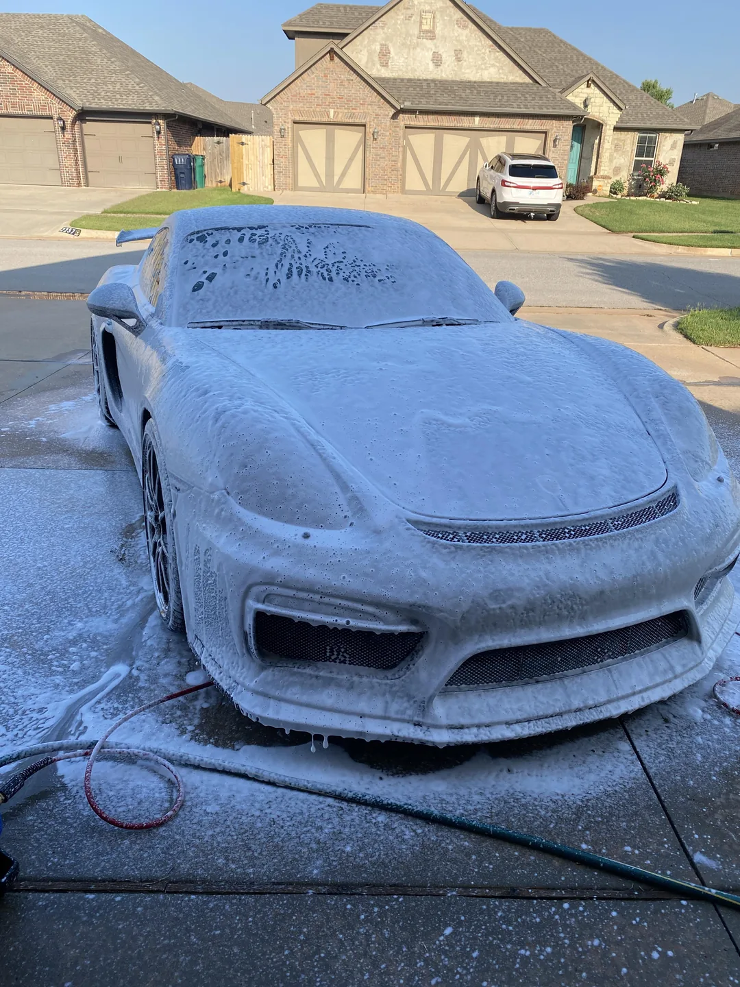 Porsche Cayman covered in foam during a Premium Exterior Detail